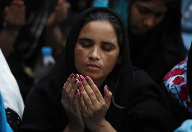 A Pakistani Christian woman prays during a Good Friday service at Saint Anthony Church in Lahore March 29, 2013. Holy Week is celebrated in many Christian traditions during the week before Easter. (Photo by Mohsin Raza/Reuters)
