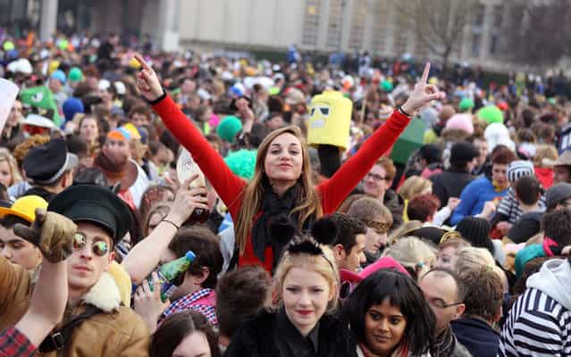 People dance in a street as they take part in the student carnival on March 28, 2013 in Caen, northwestern France. Caen's student carnival is the biggest student carnival of France, with 12,000-14,000 students in attendance according to the authorities. (Photo by Charly Triballeau/AFP Photo)