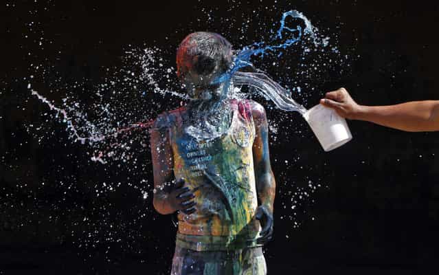 A boy smeared with colours reacts as another boy pours water on him during Holi celebrations in the southern Indian city of Chennai March 27, 2013. Holi, also known as the Festival of Colours, heralds the beginning of spring and is celebrated all over India. (Photo by Babu/Reuters) A boy smeared with colours reacts as another boy pours water on him during Holi celebrations in the southern Indian city of Chennai March 27, 2013. Holi, also known as the Festival of Colours, heralds the beginning of spring and is celebrated all over India. (Photo by Babu/Reuters)
