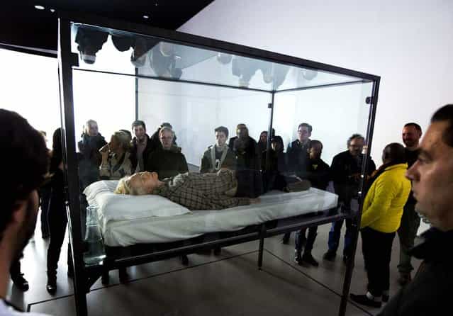 Actress Tilda Swinton performs the art of sleeping in her one-person piece called [The Maybe], in New York's Museum of Modern Art, on March 25, 2013. In [The Maybe], first performed at the Serpentine Gallery in London in 1995, Swinton lies sleeping in a glass box for the day. The exhibit will move locations within the museum every time Swinton performs. (Photo by Richard Drew/Associated Press)