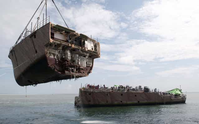 In this photo released by the Philippine Coast Guard in Manila, Wednesday, March 27, 2013, the bow of the USS Guardian, a US Navy minesweeper, is lifted by a crane during a continuing salvage operation off Tubbataha Reef, a World Heritage Site in the Sulu Sea, 640 kilometers (400 miles) southwest of Manila, Philippines, Tuesday March 26, 2013. Guardian ran aground on the Tubbataha Reef January 17. The U.S. Navy and contracted salvage teams continue damage assessments and the removal of equipment and parts to prepare the grounded ship to be safely dismantled and removed from Tubbataha Reef. The U.S. Navy continues to work in close cooperation with the Philippine authorities to safely dismantle Guardian from the reef while minimizing environmental effects. (Photo by Mass Communication Specialist 3rd Class Kelby Sanders/U.S. Navy) In this photo released by the Philippine Coast Guard in Manila, Wednesday, March 27, 2013, the bow of the USS Guardian, a US Navy minesweeper, is lifted by a crane during a continuing salvage operation off Tubbataha Reef, a World Heritage Site in the Sulu Sea, 640 kilometers (400 miles) southwest of Manila, Philippines, Tuesday March 26, 2013. Guardian ran aground on the Tubbataha Reef January 17. The U.S. Navy and contracted salvage teams continue damage assessments and the removal of equipment and parts to prepare the grounded ship to be safely dismantled and removed from Tubbataha Reef. The U.S. Navy continues to work in close cooperation with the Philippine authorities to safely dismantle Guardian from the reef while minimizing environmental effects. (Photo by Mass Communication Specialist 3rd Class Kelby Sanders/U.S. Navy)