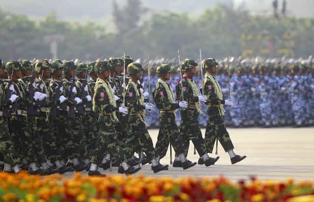 A guard of honour contingent marches during a parade to mark the 68th anniversary of Armed Forces Day in Myanmar's capital Naypyitaw March 27, 2013. The parade commemorates the day, March 27, 1945, when independence hero General Aung San gave the command to the units of the independence army to launch a nation-wide resistance against the Japanese occupation. (Photo by Soe Zeya Tun/Reuters)