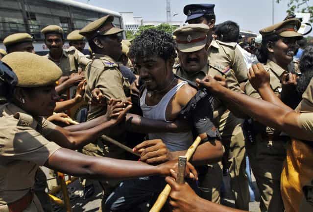 Police detain a college student during a protest in the southern Indian city of Chennai March 27, 2013. Dozens of students on Wednesday held a protest against Sri Lanka demanding the probe into war crimes, the protesting students said. The United Nations urged Sri Lanka in a resolution last week to carry out credible investigations into killings and disappearances during its nearly 30-year civil war, especially in the brutal final stages in 2009. (Photo by Babu/Reuters) Police detain a college student during a protest in the southern Indian city of Chennai March 27, 2013. Dozens of students on Wednesday held a protest against Sri Lanka demanding the probe into war crimes, the protesting students said. The United Nations urged Sri Lanka in a resolution last week to carry out credible investigations into killings and disappearances during its nearly 30-year civil war, especially in the brutal final stages in 2009. (Photo by Babu/Reuters)