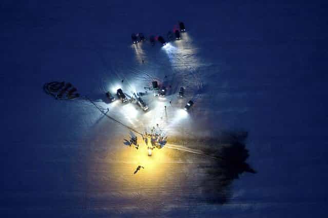 Recovery vehicles surround the Soyuz TMA-05M spacecraft seen shortly after a successful landing with the ISS crew of Japanese astronaut Aki Hoshide, Russian cosmonaut Yury Malenchenko and U.S. astronaut Sunita Williams near the town of Arkalyk, Kazakhstan, on November 19, 2012. (Photo by Sergei Remezov/AP Photo/The Atlantic)
