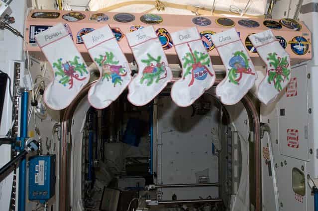 Stockings, hung with care on Christmas Day, 2012 aboard the ISS. The individual names of the six Expedition 34 crew members are inscribed on their respective stockings. The scene is actually in Node 1, called Unity, which was the first U.S.-built element that was launched, and it connects the U.S. and Russian segments of the orbital outpost. (Photo by NASA/The Atlantic)