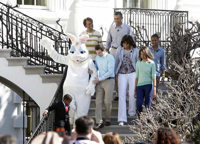 U.S. President Barack Obama (top C), first lady Michelle Obama (3rd R) and their daughters Malia (2nd R) and Sasha (R) arrive with the Easter Bunny for the Easter Egg Roll on the South Lawn of the White House in Washington, April 1, 2013. Also pictured are the first lady's mother Marian Robinson (top L) and Robbie Novak (bottom L), who goes by the stage name Kid President. (Photo by Jonathan Ernst/Reuters)