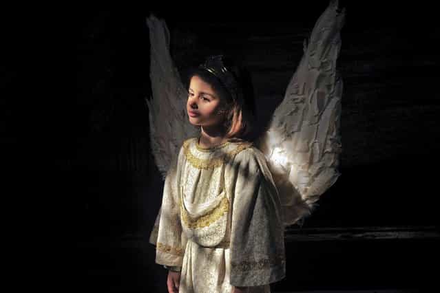Celia de La Vega, 7, dressed as an angel, during the Easter Sunday ceremony [Descent of the Angel]', during Holy Week in the small town of Tudela, northern Spain, Sunday, March 31, 2013. (Photo by Alvaro Barrientos/AP Photo)