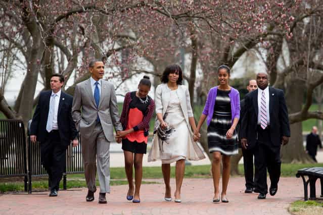 President Barack Obama, daughter Sasha, first lady Michelle Obama and daughter Malia walk across Lafayette Park from the White House on their way to Easter services at St John's Episcopal Church March 31, 2013 in Washington, D.C. (Photo by Drew Angerer/Pool)