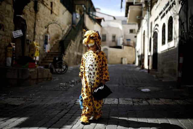 An ultra-orthodox Jewish boy wears a costume ahead of the Jewish holiday of Purim in Jerusalem's Mea Shearim neighborhood, on February 22, 2013. (Photo by Amir Cohen/Reuters /The Atlantic)
