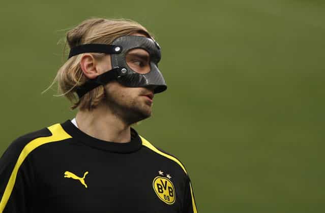 Marcel Schmelzer of German soccer team Borussia Dortmund wears a protective mask during a training session at La Rosaleda stadium in Malaga, southern Spain, on April 2, 2013. (Photo by Jon Nazca/Reuters /The Atlantic)