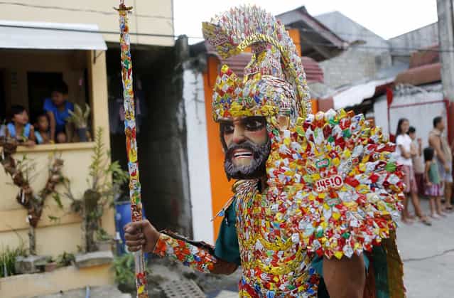A penitent in a costume made of candy wrappers takes part in a procession for the Moriones Festival during Holy Week in Mogpog town on Marinduque island, central Philippines, on March 27, 2013. During the festival, masked and costumed penitents called [Moriones] dress in attire that is the local interpretation of what Roman soldiers wore during biblical times. (Photo by Erik De Castro/Reuters /The Atlantic)