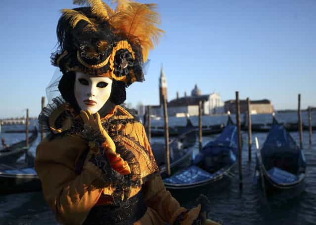 A masked reveller poses in Saint Mark's Square during the Venetian Carnival in Venice, on February 3, 2013. (Photo by Manuel Silvestri/Reuters /The Atlantic)