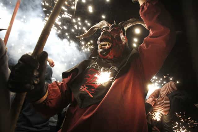 A reveler wearing a demon costume takes part in the traditional festival of [Correfoc] in Palma de Mallorca, on January 21, 2013. Participants dress as demons and devils and move through the streets scaring people with fire and fireworks. (Photo by Jaime Reina/AFP Photo /The Atlantic)
