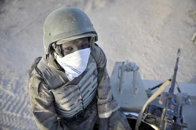 A Ugandan soldier sits on top of his armored vehicle on the first day of an advance to oust militant group Al Shabab from several towns in the Lower Shabelle region of Somalia, on February 12, 2013. (Photo by Tobin Jones/Reuters/AU-UN IST Photo /The Atlantic)