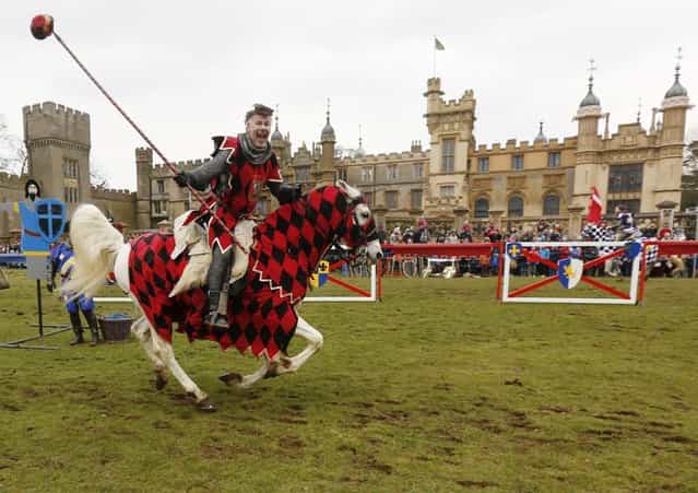 A performer dressed as a medievel knight shows off jousting skills at Knebworth House in Hertfordshire, UK, April 1, 2013. Knebworth House, a stately home of the Lytton family since 1490, hosted The Knights Of Royal England in their first medievel jousting tournament of the season. (Photo by Olivia Harris/Reuters)