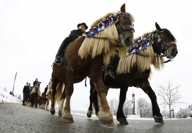 Pilgrims dressed in traditional Bavarian clothes attend the traditional Georgi horse riding procession on Easter Monday in the southern Bavarian town of Traunstein April 1, 2013. Since the early 16th century, farmers have taken part in the pilgrimage to bless their horses. This tradition, the [Georgiritt], goes back to the legend of Saint George, the horsemen's patron saint. (Photo by Michaela Rehle/Reuters)