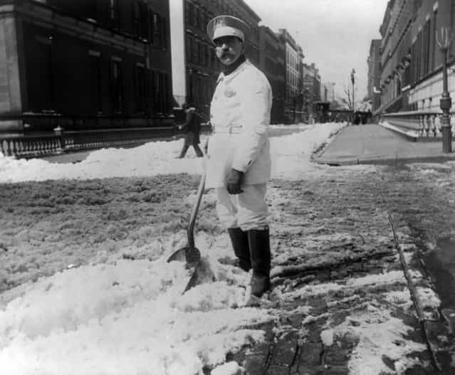 Street types of New York City: Street cleaner with rubber boots shoveling snow, circa 1896. (Photo by Elizabeth Alice Austen)