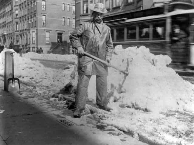 Street types of New York City: Street cleaner with pick ax standing in front of pile of snow, circa 1896. (Photo by Elizabeth Alice Austen)