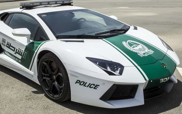 A Lamborghini Aventador is the latest addition to the Dubai Police fleet, on April 11, 2013. Dubai already has the world's tallest building, the world's largest shopping mall, and the largest man-made archipelago. So it's no surprise that the country's police would drive one of the world's most extravagant and expensive cars. The latest addition to the force's fleet is a head-turning Lamborghini Aventador, finished in green and white – the colors of the Dubai Police force. (Photo by AFP Photo/Polícia de Dubai)