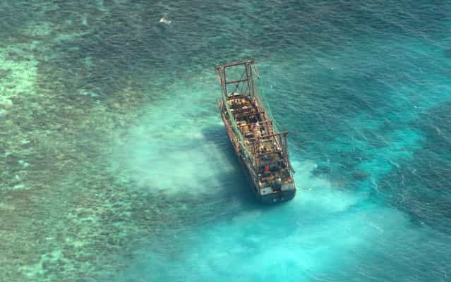 A Chinese fishing vessel that ran aground in Tubbataha Reef, a UNESCO World Heritage site, on Monday is pictured in Palawan Province, west of Manila April 10, 2013 in this picture provided by Naval Forces West. (Photo by Reuters/Naval Forces West)
