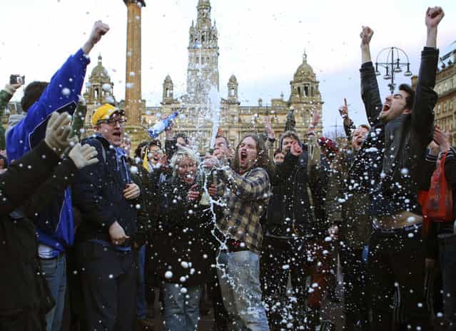 Revellers spray a bottle of champagne as they celebrate the death of former British prime minister Margaret Thatcher, at George Square in Glasgow, Scotland April 8, 2013. Margaret Thatcher, the [Iron Lady] who transformed Britain and inspired conservatives around the world by radically rolling back the state during her 11 years in power, died on Monday following a stroke. She was 87. (Photo by David Moir/Reuters)