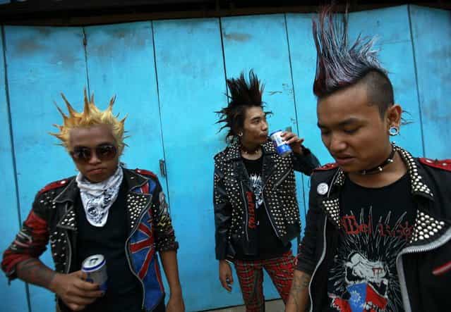 Youths dressed as punks drink beer as they wait for a punk music show during the Myanmar New Year Water Festival in Yangon April 12, 2013. Myanmar celebrates the New Year Water Festival of Thingyan during the month of Tagu, which usually falls around mid-April. (Photo by Soe Zeya Tun/Reuters)
