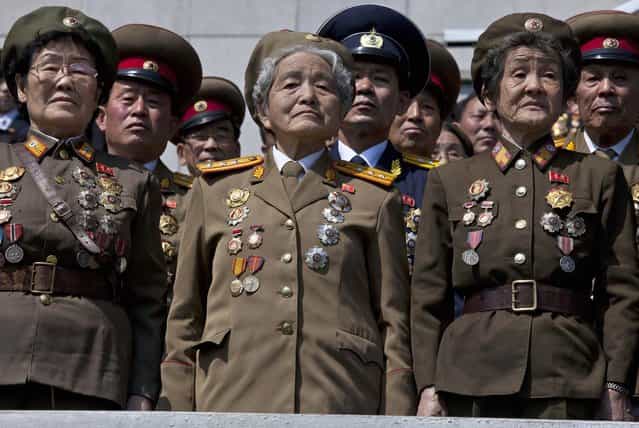 Retired North Korean military members stand at attention during an induction ceremony for children into the Korean Children's Union, the first political organization for North Koreans, held at a stadium in Pyongyang on Friday, April 12, 2013. (Photo by David Guttenfelder/AP Photo)