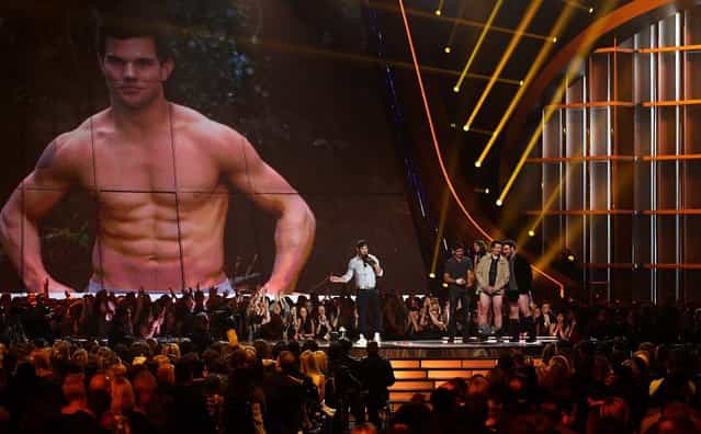 Taylor Lautner accepts the award for best shirtless performance for [The Twilight Saga: Breaking Dawn – Part 2]. (Photo by Matt Sayles/Invision)