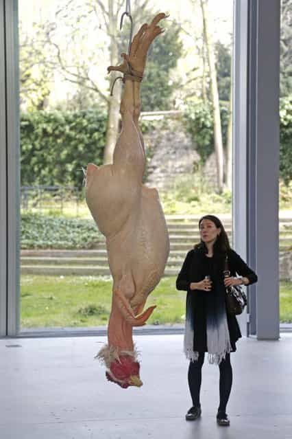 A visitor looks at a sculpture entitled [Still Life] (2002) by artist Ron Mueck during the press day for his exhibition at the Fondation Cartier pour l'art contemporain in Paris April 15, 2013. (Photo by Charles Platiau/Reuters)