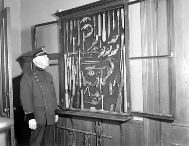 Somerville police chief Thomas Damery with collection of murder weapons from 32 years of running down slayers, 1931. (Photo by Leslie Jones)