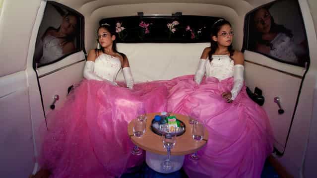 The twins Laura and Beln on the day of their fifteenth birthday celebration. In Latin America, the celebration of the fifteenth birthday of a teenager is very important because it marks the transition from childhood to maturity. (Photo by Myriam Meloni/2013 Sony World Photography Awards)