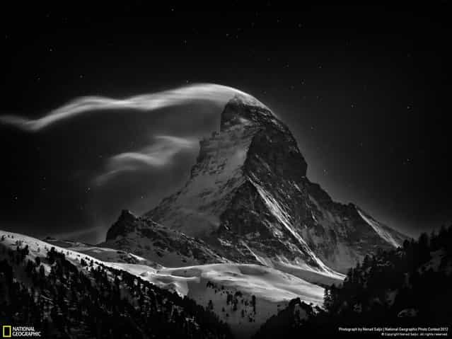 Winner, Professional Landscape. A Portrait of the Matterhorn. When I was young, I had long fantasized about climbing the Matterhorn but I never really had the chance. The Matterhorn was the last great Alpine peak to be conquered and its first ascent in 1865 marked the end of the golden age of alpinism. Its North Face, which is on all images, is amongst the [Three Great Problems] in the Alps and was not climbed until 1931. I have been around Zermatt countless times, the village nestled at the foot of the Matterhorn, looking toward the mountains and trying to capture the exquisiteness of this magical peak and its endless state of change; to compress the passing of time the beauty of the wind and the clouds dancing around the mountain. This portfolio is a kind of memento to all climbers who dared to go there and for those who never returned. Night Clouds #3, 07 Jan 2012 – 3:17 AM – Matterhorn at full moon. (Photo by Nenad Saljic/2013 Sony World Photography Awards)