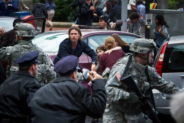 June 21: [World War Z]. Brad Pitt battles zombie apocalypse in $170 million film by [Quantum of Solace] director Marc Forster. This publicity photo released by Paramount Pictures shows, center, Brad Pitt as Gerald Lane in a scene from the film, [World War Z], from Paramount Pictures and Skydance Productions in association with Hemisphere Media Capital and GK Films. (Photo by Jaap Buitendijk/AP Photo/Paramount Pictures)