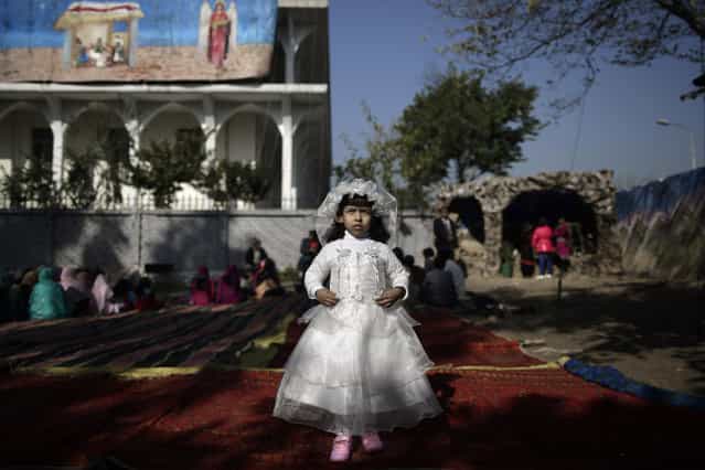 Pakistani Anusha Khalid, 4, dressed as a bride, poses for a picture at an outdoor Mass on Christmas Day, in a Christian neighborhood in Islamabad, Pakistan, Tuesday, December 25, 2012. (Photo by Muhammed Muheisen/AP Photo)