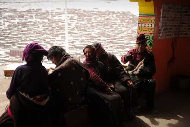 This photo taken on April 5, 2013 shows Tibetans who have made a pilgramage to Seda Monastery, the largest Tibetan Buddhist school in the world, with up to 40,000 monks and nuns in residence for some parts of the year. Seda, known to Tibetans as Serthar is located in Ganzi prefecture in the west of China's Sichuan province and has become a hotbed of protests and violence since the Tibetan uprisings of March 2008. More than 110 Tibetans have set themselves alight since 2009, with most dying of their injuries, in demonstrations against what they view as Chinese oppression which Beijing rejects pointing to substantial investment in Tibet and other regions with large Tibetan populations, although critics say economic development has brought an influx of ethnic Han Chinese and eroded traditional Tibetan culture. (Photo by Peter Parks/AFP Photo)