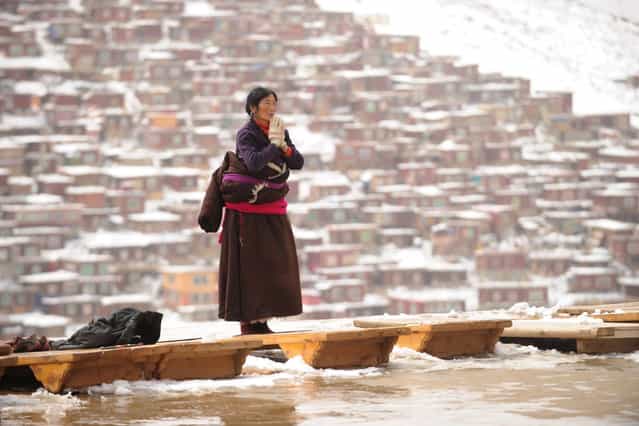 This photo taken on April 5, 2013 shows a Tibetans who has made a pilgramage to Seda Monastery, the largest Tibetan Buddhist school in the world, with up to 40,000 monks and nuns in residence for some parts of the year. Seda, known to Tibetans as Serthar is located in Ganzi prefecture in the west of China's Sichuan province and has become a hotbed of protests and violence since the Tibetan uprisings of March 2008. More than 110 Tibetans have set themselves alight since 2009, with most dying of their injuries, in demonstrations against what they view as Chinese oppression which Beijing rejects pointing to substantial investment in Tibet and other regions with large Tibetan populations, although critics say economic development has brought an influx of ethnic Han Chinese and eroded traditional Tibetan culture. (Photo by Peter Parks/AFP Photo)