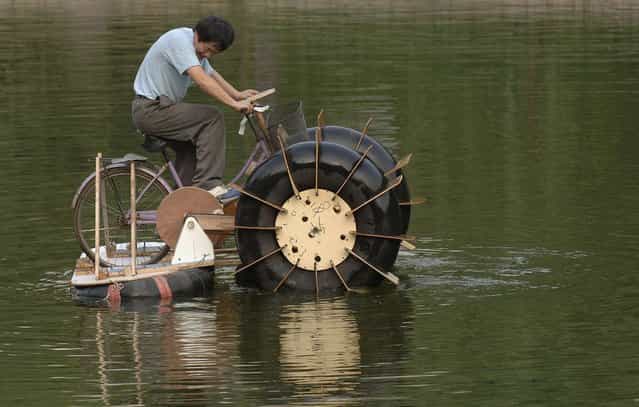Li Zhiyuan rides a paddle boat made of a bicycle and recycled materials at a park in Hefei, China. Li, the designer of the paddle boat, spent one month making it using a bicycle, trashed wood and tyres. It cost him less than 20 dollars. China is the world’s largest garbage importer. In 2008, the U.S. exported 11.6 million tons of recovered paper and cardboard to China. Chinese consumption simply doesn't produce enough waste to feed the country’s recycling industry. (Photo by Reuters/Stringer)