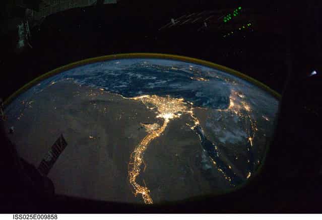A night time photograph made by an International Space Station Expedition 25 crewmember shows the bright lights of Cairo and Alexandria, Egypt on the Mediterranean coast as well as the Nile River and its delta which stand out clearly in this image released by NASA and taken October 28, 2010. (Photo by Reuters/NASA)