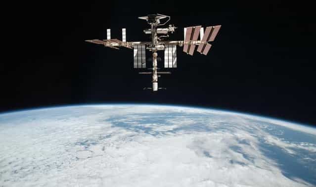 This May 23, 2011 file photo released by NASA shows the International Space Station at an altitude of approximately 220 miles above the Earth, taken by Expedition 27 crew member Paolo Nespoli from the Soyuz TMA-20 following its undocking. NASA on Thursday, May 9, 2013 said the International Space Station has a radiator leak in its power system. The outpost's commander calls the situation serious, but not life-threatening. (Photo by Paolo Nespoli/AP Photo/NASA)