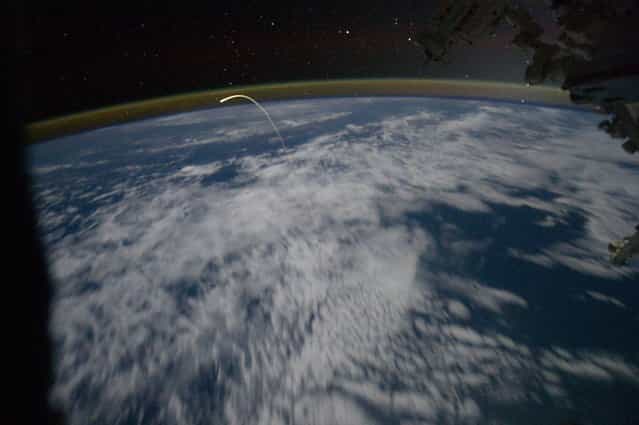 A member of the Expedition 28 crew aboard the International Space Station caught this spectacular photo of a lifetime, showing space shuttle Atlantis actually hurtling through the Earth's atmosphere on its way back to Kennedy Space Center, Florida, July 21, 2011. (Photo by NASA/Johnson Space Center)