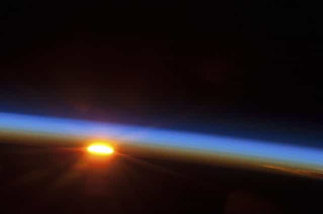 In this image provided by NASA, the sun rises over the South Pacific Ocean photographed by one of the Expedition 35 crew members aboard the Earth-orbiting International Space Station between 4 and 5 a.m. local time, May 5, 2013. (Photo by NASA)