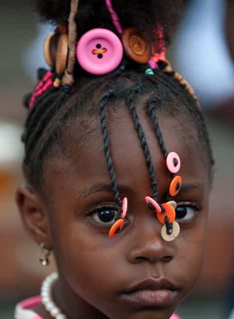 A girl presents an Afro-Colombian hairstyle during the 9th contest of Afro-hairdressers, in Cali, Valle del Cauca departament, Colombia, on May 12, 2013. The Afro hairstyles have their origins in the time of slavery, when women sat to comb their children hair after work. (Photo by Luis Robayo/AFP Photo)