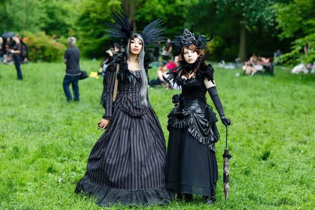 Participants in black clothing and feather-hats pose for pictures during the traditional park picnic on the first day of the annual Wave-Gotik Treffen, or Wave and Goth Festival, on May 17, 2013 in Leipzig, Germany. The four-day festival, in which elaborate fashion is a must, brings together over 20,000 Wave, Goth and steam punk enthusiasts from all over the world for concerts, readings, films, a Middle Ages market and workshops. (Photo by Marco Prosch)