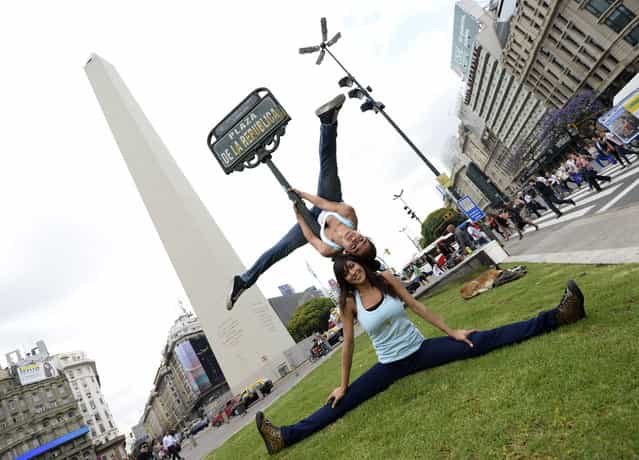 Participants in the Pole Dance Argentina 2012 and Pole Dance South America 2012 competitions perform in downtown Buenos Aires on November 23, 2012 ahead of the contest to be held on November 24 and 26 in Buenos Aires. (Photo by Juan Mabromata/AFP Photo)