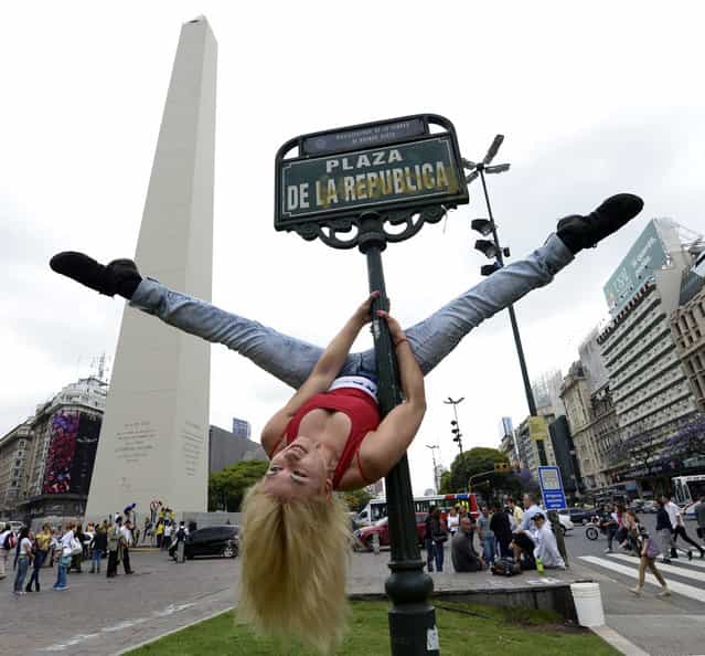 A Paraguayan participant in the Pole Dance South America 2012 competition performs at Republica square in downtown Buenos Aires on November 23, 2012 ahead of the contest to be held on November 24 and 26 in Buenos Aires. (Photo by Juan Mabromata/AFP Photo)