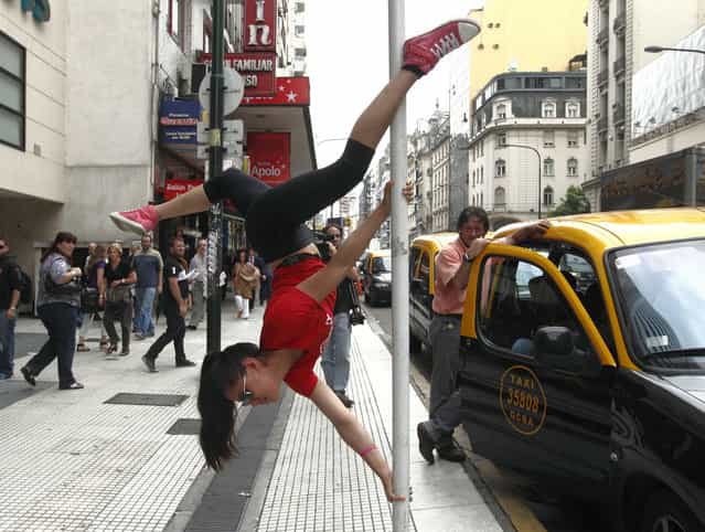 Mariela Duffoo, from Peru, performs a pole dancing routine to promote the Miss Pole Dance South America 2012 competition in Buenos Aires November 23, 2012. (Photo by Enrique Marcarian/Reuters)