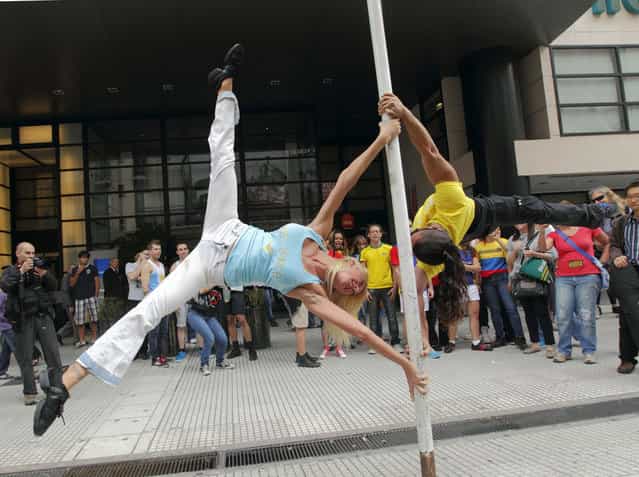 Daniela Schmoll, of Argentina (L), performs a pole dancing routine to promote the Miss Pole Dance South America 2012 competition in Buenos Aires November 23, 2012. (Photo by Enrique Marcarian/Reuters)