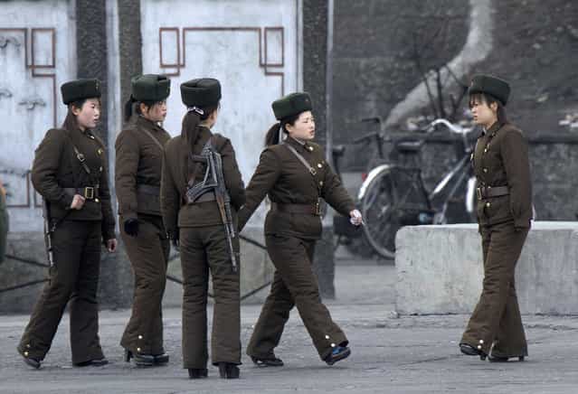 In this Thursday, April 11, 2013 photo, North Korean female soldiers perform marching exercise on the river bank of the North Korean town of Sinuiju, opposite to the Chinese border city of Dandong. (Photo by AP Photo)