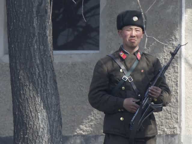 A North Korean soldier on the bank of the Yalu River, near the North Korean town of Sinuiju, along the Chinese border. (Photo by Jacky Chen/Reuters)