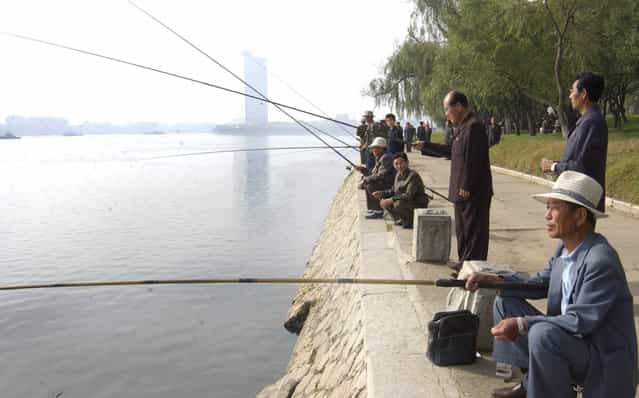 North Koreans fish on the bank of the River Taedong during an event held by the Central Committee of the Federation for the Care of the Elderly of Korea on the occasion of the 20th International Day of Old Persons in Pyongyang, October 1, 2010 in this picture released by the North Korea's KCNA news agency. (Photo by Jacky Chen/Reuters)